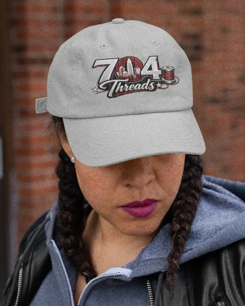 Girl wearing a gray 704 Threads dad hat.