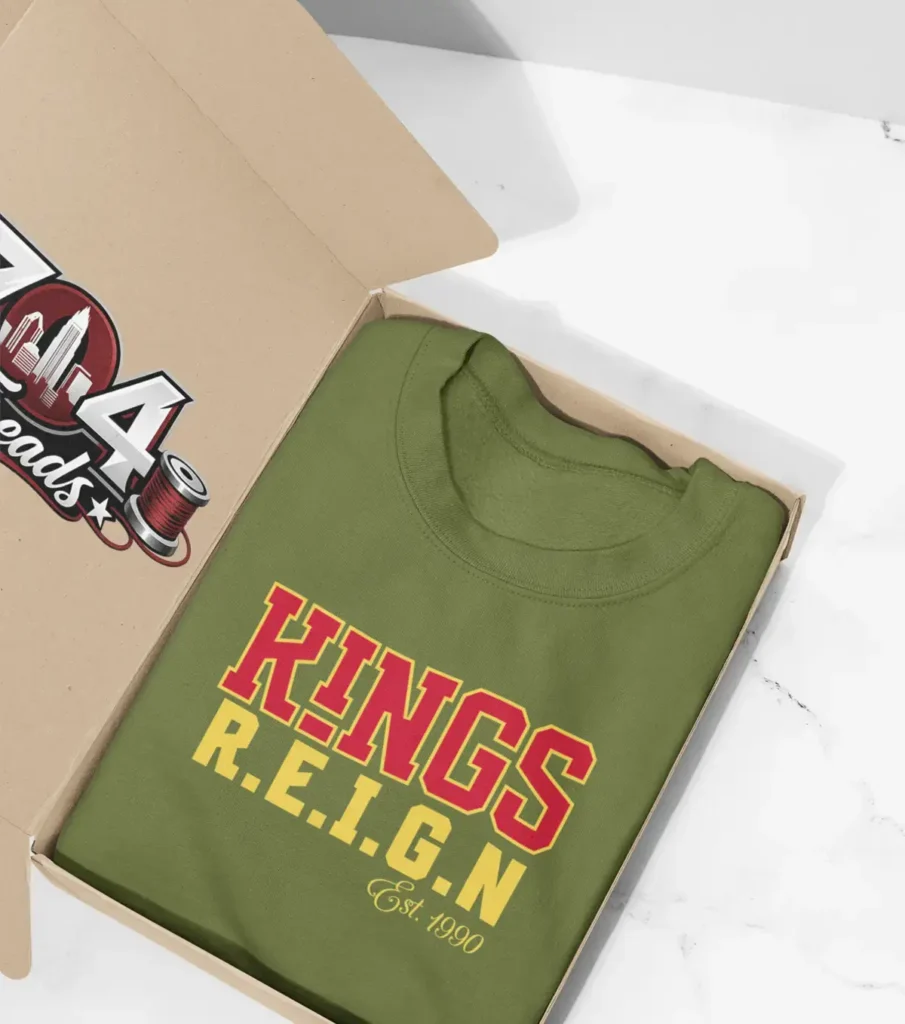Green sweatshirt with the words "King's R.E.I.G.N" printed in red and yellow.